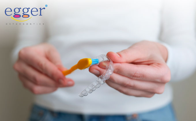 Keeping clean Invisalign clear aligners is essential for optimal results for your teenager's orthodontic treatment.