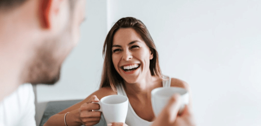 Woman enjoying coffee while wearing Invisalign