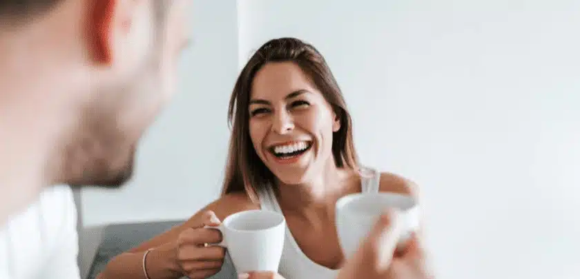 Woman enjoying coffee while wearing Invisalign