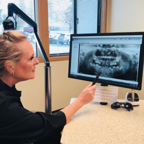 Digital X-Ray Review An orthodontist at Egger Orthodontics reviewing a digital panoramic dental x-ray.